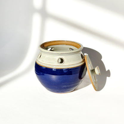 Image: A cobalt blue ceramic garlic keeper, designed to keep garlic bulbs fresh and ready for use.