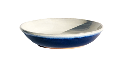 Image: A large pasta dish with a diameter of 10 inches, meticulously handmade by Clinton Pottery, showcasing a rich cobalt glaze. The intense blue hue of the glaze exudes sophistication and elegance, making it an exquisite option for presenting generous portions of pasta dishes with a modern twist.