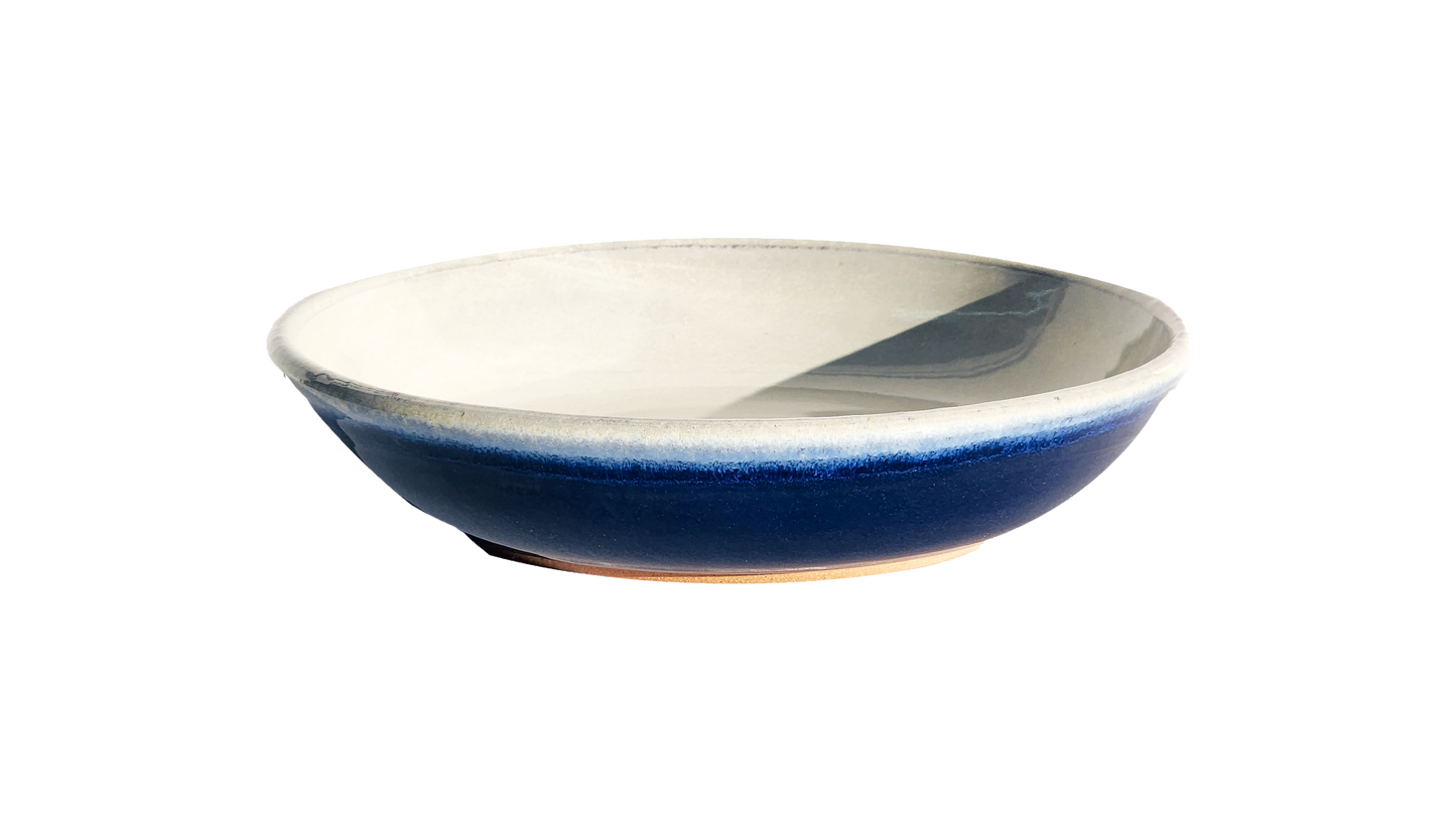 Image: A small pasta dish with a diameter of 8.5 inches, crafted by Clinton Pottery, displaying a vibrant cobalt glaze. The deep blue color of the glaze adds a bold and striking element, making it an eye-catching choice for serving pasta dishes with a touch of contemporary flair.