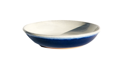 Image: A small pasta dish with a diameter of 8.5 inches, crafted by Clinton Pottery, displaying a vibrant cobalt glaze. The deep blue color of the glaze adds a bold and striking element, making it an eye-catching choice for serving pasta dishes with a touch of contemporary flair.