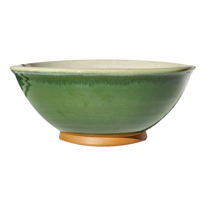 Image: A large mixing bowl in rich dark green, offering plenty of room with a capacity of 12.5 cups. Bring the beauty of nature into your kitchen while preparing delicious meals.