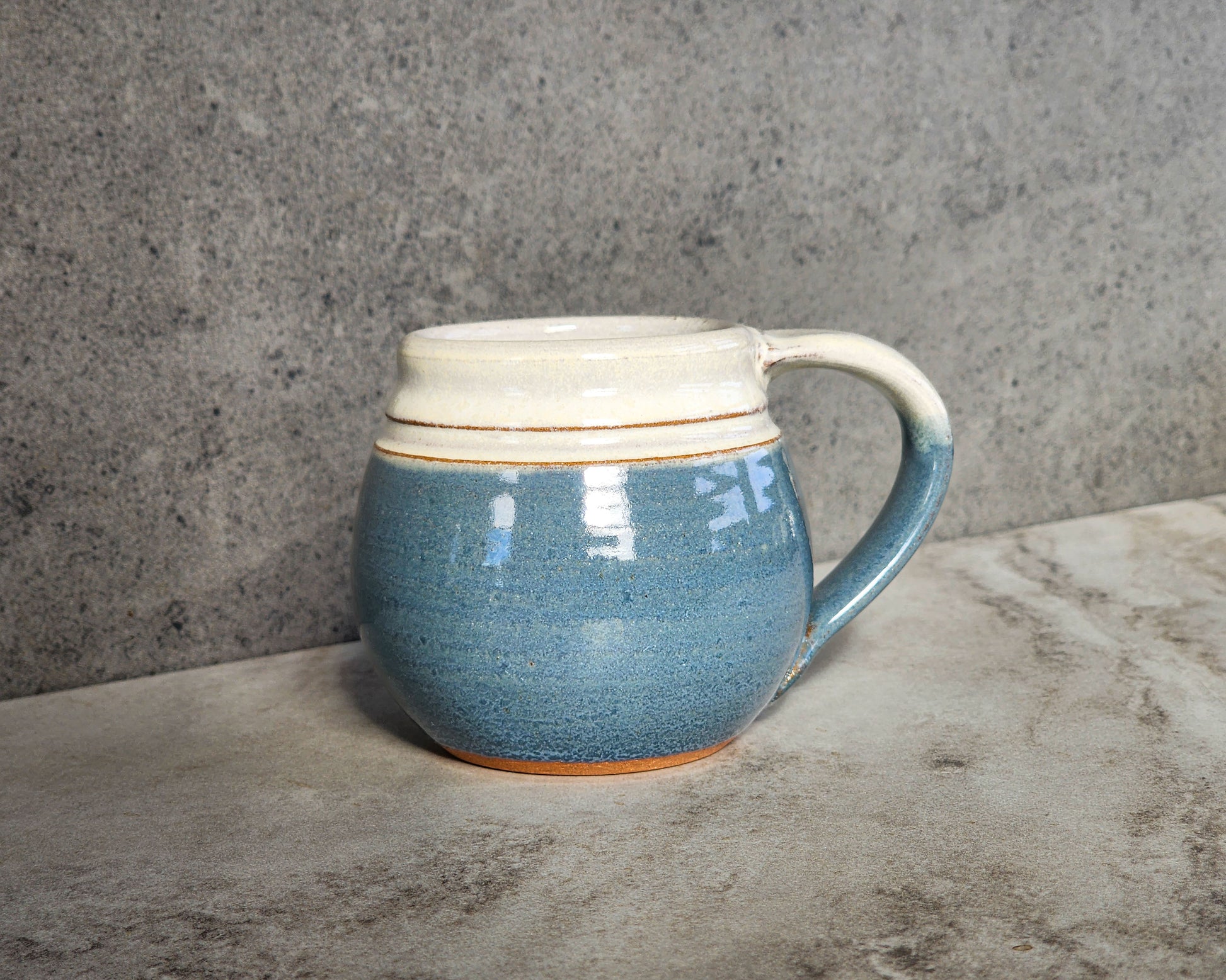 Light Blue: Refresh your senses with the Light Blue small mug by Clinton Pottery. Its tranquil blue color evokes images of clear skies and calm waters, bringing a sense of serenity to your coffee or tea time. Start your day on a peaceful note with this soothing mug.