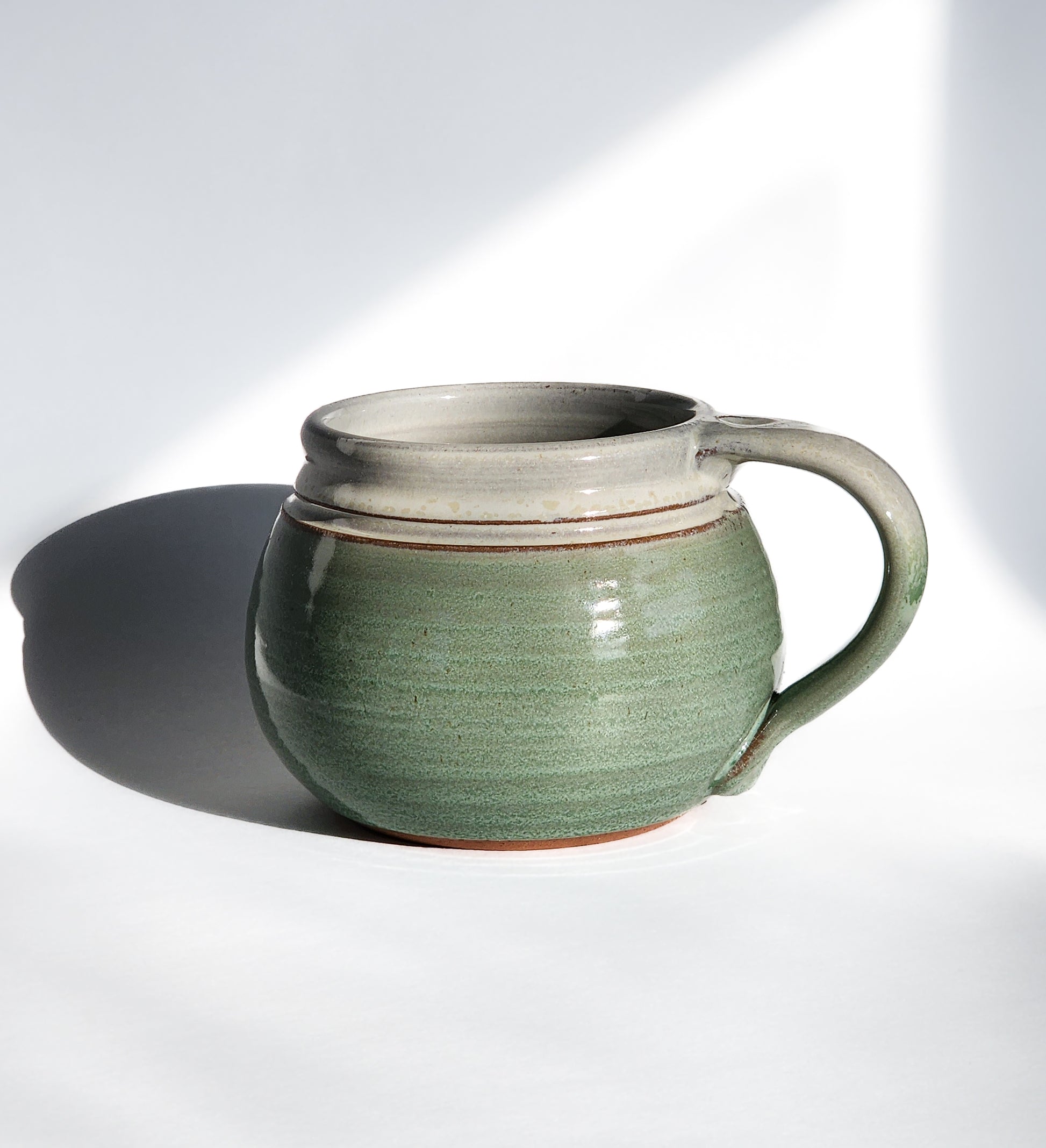 Image: Clinton Pottery's 24 oz Cereal/Soup Mug in Light Green – A fresh and invigorating addition to your kitchen, this machine washable mug seamlessly blends artistry with functionality. The Light Green color adds a touch of nature's vitality, reminiscent of lush greenery and sunlit meadows. Perfect for enjoying your favorite cereal or soup, bringing a breath of natural elegance to your dining experience.