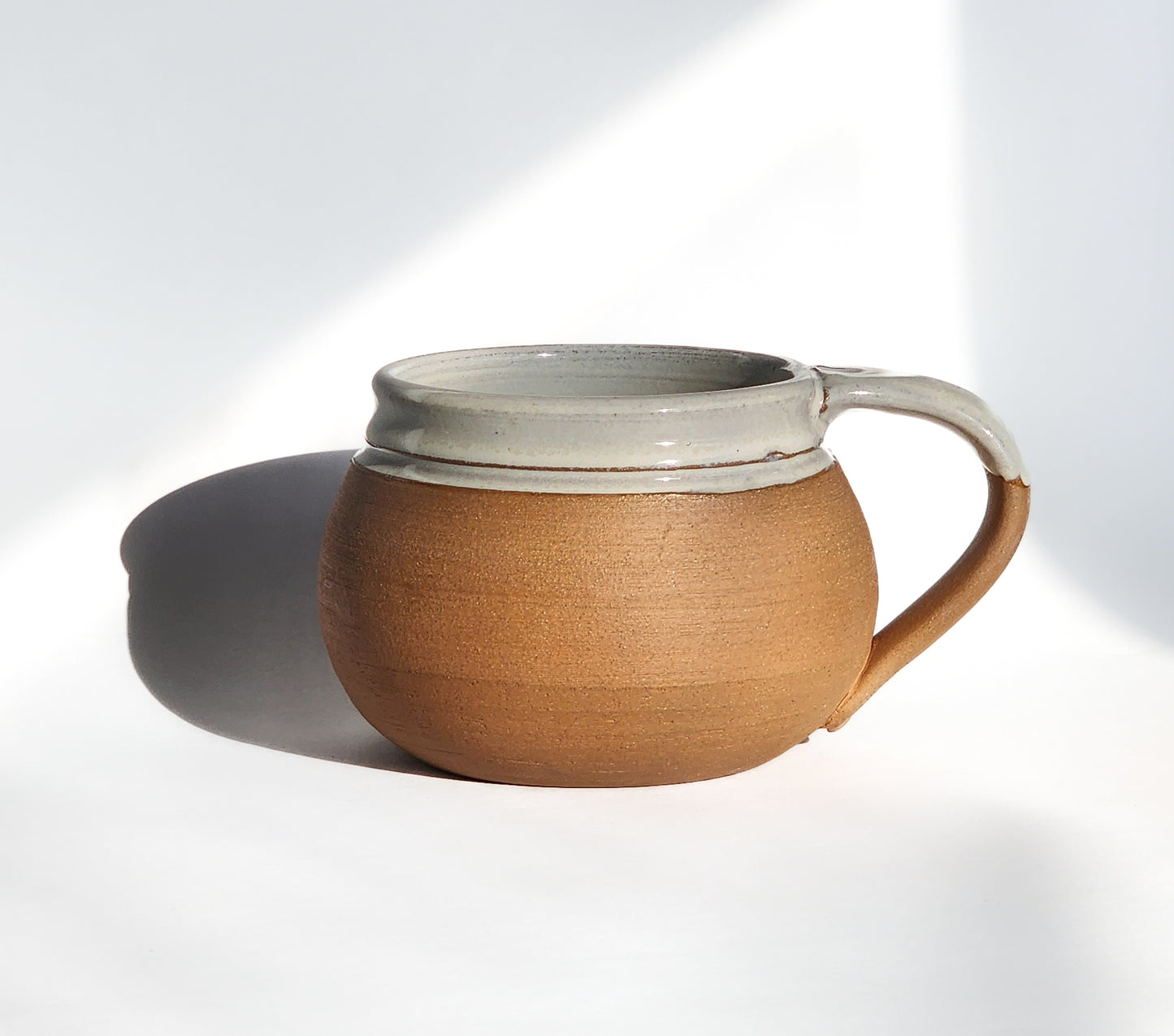 Image: Clinton Pottery's 24 oz Cereal/Soup Mug in Natural (Unglazed) – Embracing simplicity and authenticity, this machine washable mug seamlessly blends artistry with functionality. The unglazed exterior offers a raw and organic feel, reminiscent of earthen pottery and rustic charm. Perfect for enjoying your favorite cereal or soup, bringing a touch of elemental elegance to your dining experience.
