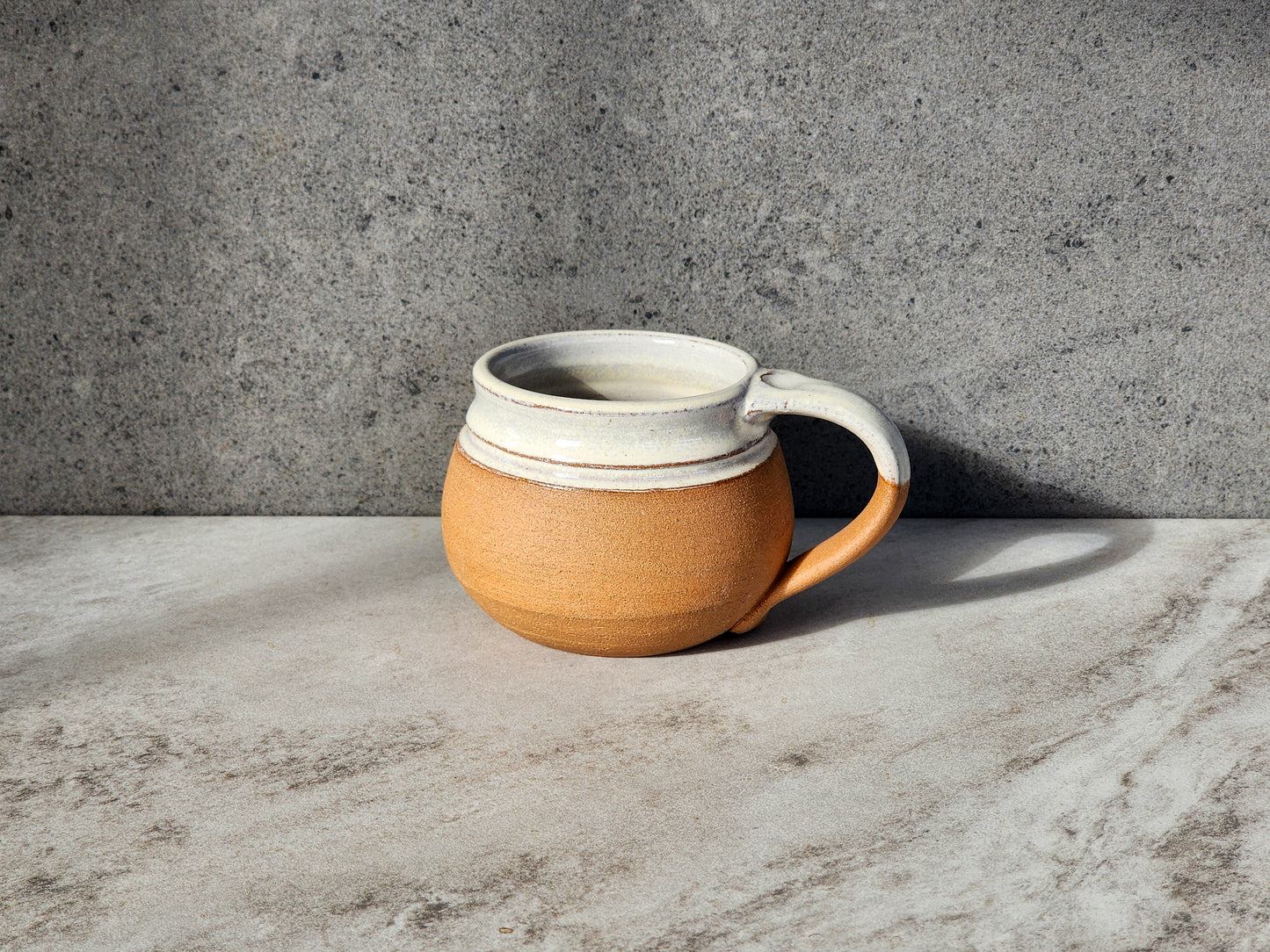 Natural: Celebrate simplicity with the Natural small mug by Clinton Pottery. Its unglazed, earthy finish highlights the natural beauty of the clay, creating a rustic yet refined look. Whether you're enjoying a morning cup of coffee or an evening herbal tea, this mug is a timeless addition to your kitchen.