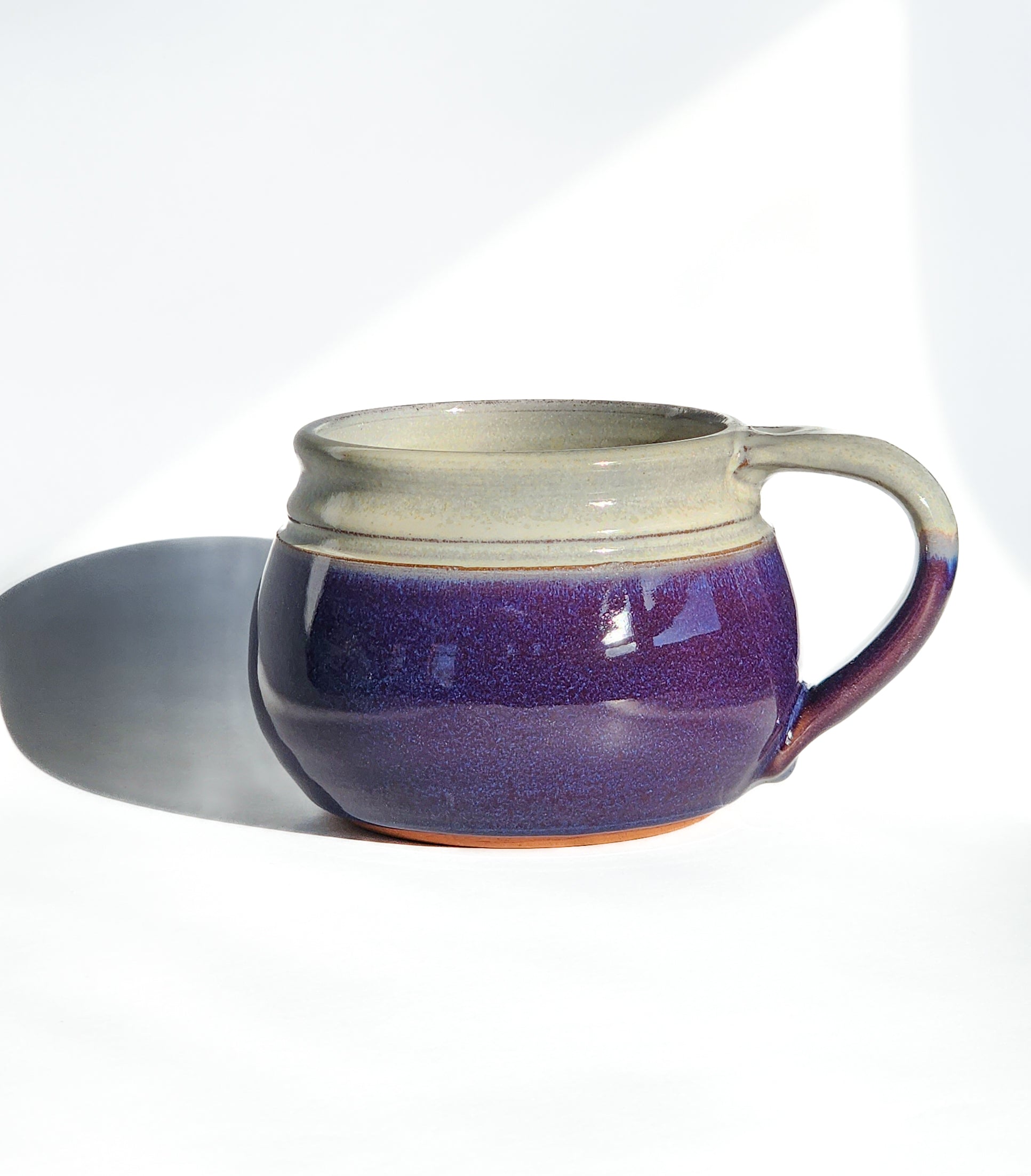 Image: Clinton Pottery's 24 oz Cereal/Soup Mug in Purple – A regal and sophisticated choice for your kitchen, this machine washable mug seamlessly blends artistry with functionality. The rich Purple color adds a touch of elegance, reminiscent of royal hues and blooming lavender fields. Perfect for savoring your favorite cereal or soup with a splash of majestic charm.