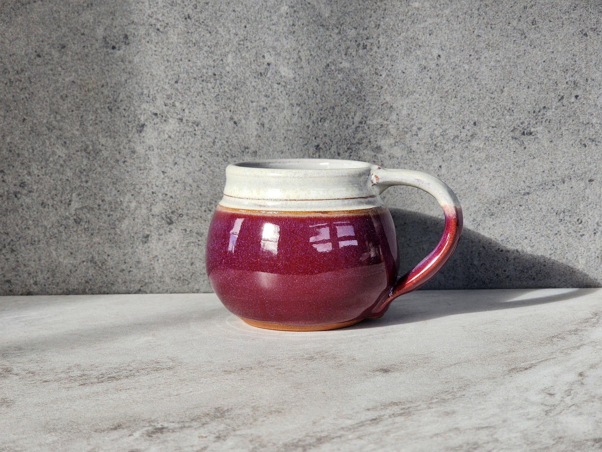 Red: Make a bold statement with the Red small mug by Clinton Pottery. Its rich, fiery hue adds a splash of excitement to your coffee or tea time, invigorating your senses and awakening your spirit.