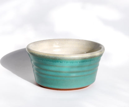 Image: Clinton Pottery's Handmade 1 Cup Flat Bottom Bowl in Sky Blue – A tranquil addition to your kitchen, this machine washable bowl seamlessly marries artistry with practicality. The soothing Sky Blue color brings a touch of serenity, reminiscent of clear skies and peaceful horizons. Ideal for serving snacks or adding a breath of calming elegance to your culinary space.