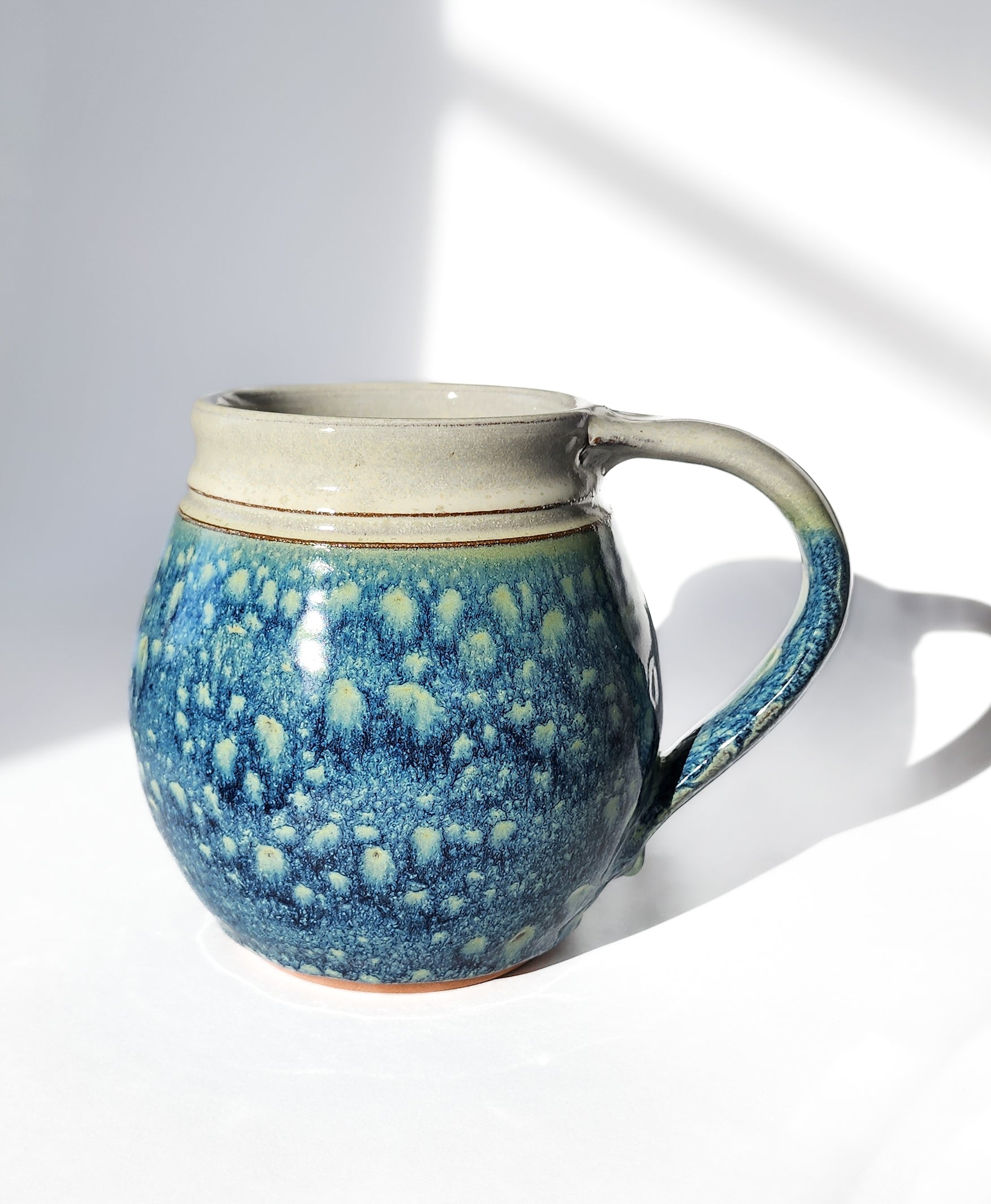 Image: Clinton Pottery's 30 oz Jumbo Mug in Starry Night – A celestial and generously sized addition to your kitchen, this machine washable mug seamlessly blends artistry with functionality. The captivating Starry Night color evokes the magic of the night sky, reminiscent of Van Gogh's swirling stars and cosmic wonder. Perfect for enjoying ample servings of your favorite coffee or tea with a touch of celestial elegance.