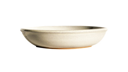  Image Description: A large pasta dish in a crisp white glaze, made by Clinton Pottery. This 10-inch dish is perfect for serving ample portions of pasta or other delicious meals, adding a touch of timeless elegance to any table setting.