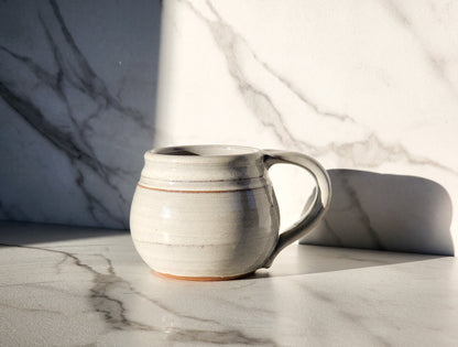 White: Embrace timeless elegance with the White small mug by Clinton Pottery. Its crisp, clean color and classic design complement any kitchen aesthetic, making it a versatile choice for everyday use. Whether you're enjoying your morning coffee or hosting a cozy tea party, this mug is sure to impress.
